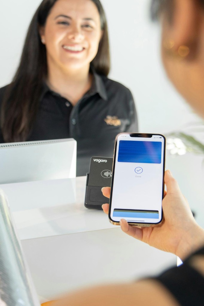 Business owner completing a fast, successful payment — funded with FundingExpressAi
